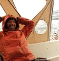 arctos guide sitting on a boat smiling | ski and sail in Norway
