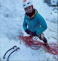 a woman in a helmet on a mountain in a ski and sail in norway