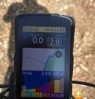a gps device mounted to a bike showing uphill climbing