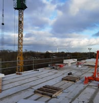 a crane is standing on a roof top