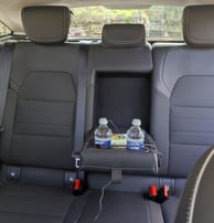 a car with a tray tray with drinks and water bottles