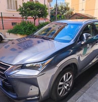 a silver car parked on the side of a street
