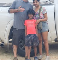 a man and woman standing in front of a truck