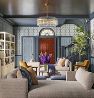 a living room with a couch and a clock