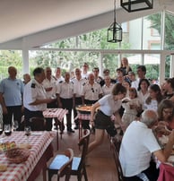 a group of people sitting at a table with food