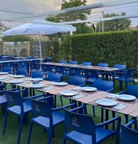 a restaurant with blue chairs and tables and umbrellas