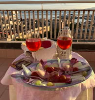 a table with a plate of food and wine glasses