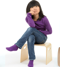 Girl wearing jeans and purple long sleeve t-shirt