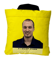 a yellow shirted pillow with a printed portrait on the back