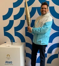 Tim Dougill holding the Paris24 Olympic torch.