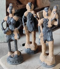 "Applying special clay over wax mould to create brass sculpture in Dhokra art, Bastar Chhattisgarh"