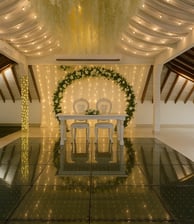 a wedding reception table with a white table cloth draped over it