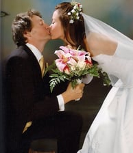 a bride and groom kissing in a wedding photo