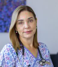 a woman in a floral print scrubsuit