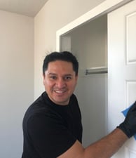 a man in black gloves and gloves is holding a blue glove