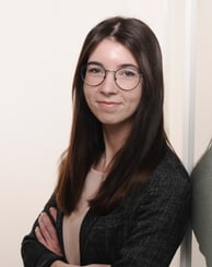 a woman in glasses and a black jacket
