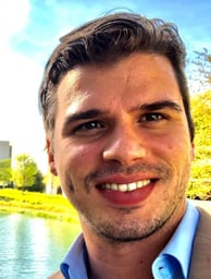 a man in a suit and tie smiling