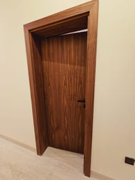 a door with a wooden door and a door handle