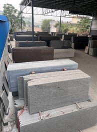 a pile of granite slabs in a gold stone granites mohali warehouse