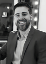 a man in a suit and tie smiling at the camera alejandro lange