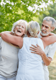 A group of older adult friends hugging