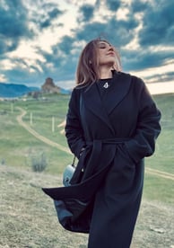 Maria Raza Sohni in a black coat and boots