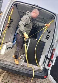 a man loading the back of a van