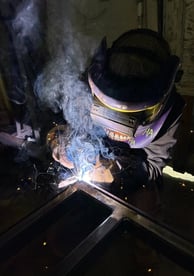 a man welding a piece of steel