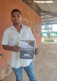 Yadir Centeno with his solar PV technician textbook