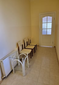 a room with a table and chairs and a door