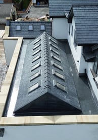 a construction worker is working on a roof