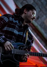 Dimitri Janiak guitariste, joue de la guitare dans la rue de la mairie devant le beffroi de Douai