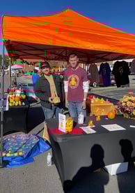 two men standing in front of a table with a table with a table cloth
