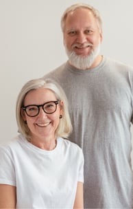 a smiling, middle-aged caucasian couple