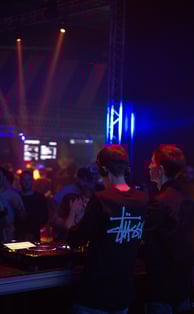 a dj spinning around in a nightclub