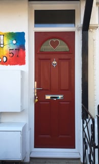 fancy front door for narrow houses. red door with bespoke heart glass