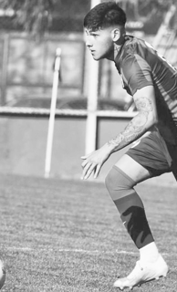 a man in a uniform playing soccer