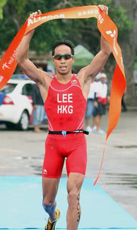 Photo of Daniel Lee, Hong Kong triathlete, crossing the finish line at the Bali 2008 triathlon