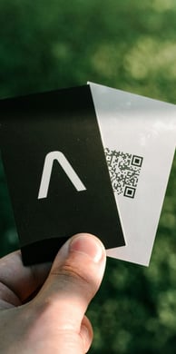 a person holding a piece of paper with a qr code on it