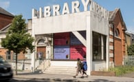 purple and pink poetry posters in library windows