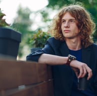 a man sitting on a bench in a park