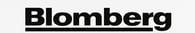 Blomberg logo above a front-loading Blomberg washing machine with a digital display, cycle selector 