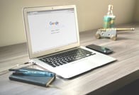 Modern workspace with a laptop open to Google search, symbolizing the importance of online visibilit