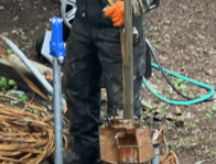 Technician snakes new well piping into hole