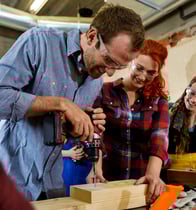 people working with wood in the makerspace