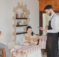 a waiter in a restaurant setting with a waiter