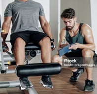 man sitting at leg extension exercise