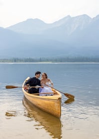 a eloping couple in a canoe on a lake