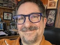 a man with glasses and a beard and mustache