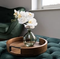 a vase with flowers in a vase on a tray orchid 